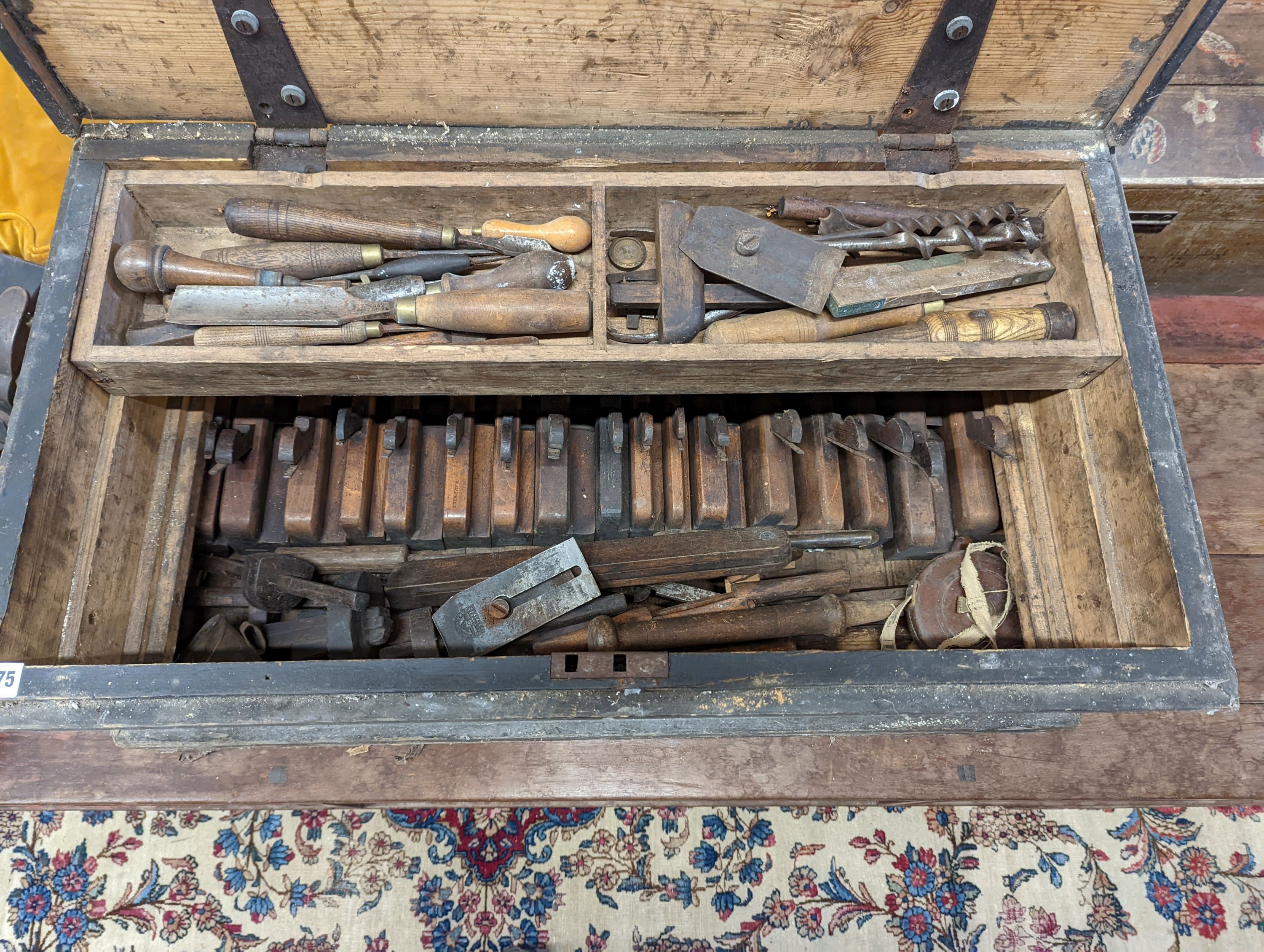 A Victorian pine carpenters chest and tools to include beech moulding planes, smoothing planes, chisels, bits, etc.